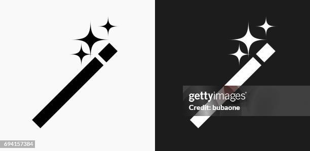 wand icon on black and white vector backgrounds - magic wand stock illustrations