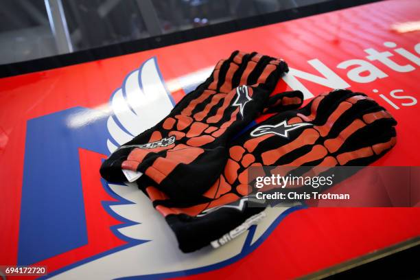 The gloves of Dale Earnhardt Jr., driver of the Axalta Chevrolet, sit on top of his car during practice for the Monster Energy NASCAR Cup Series...