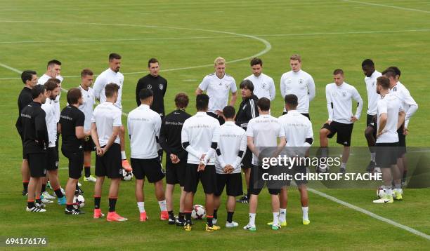 Germany's national football coach Joachim Loew speaks with players prior a training session in Herzogenaurach, southern Germany, on June 9, 2017 on...