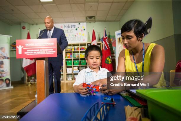 ErinOakKids student Argenio Fevidal gets help from teacher Aneesa Chan as Children and Youth Services Minister Michael Coteau announces details of...