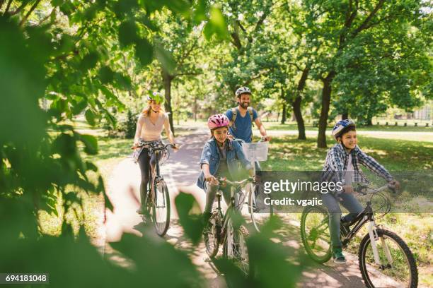family riding bicycle - cycling stock pictures, royalty-free photos & images