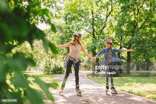 family roller skating - roller skating in park stock pictures, royalty-free photos & images