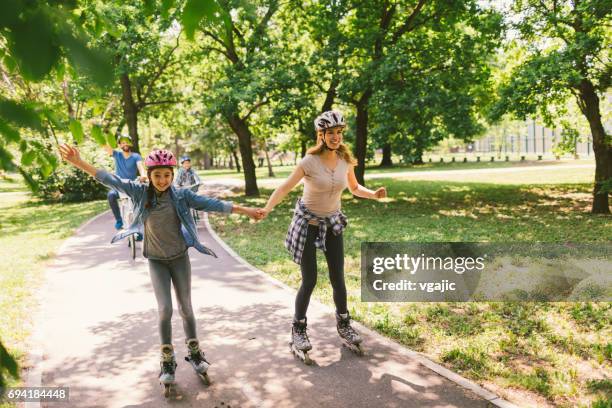 family roller skating - inline skate stock pictures, royalty-free photos & images