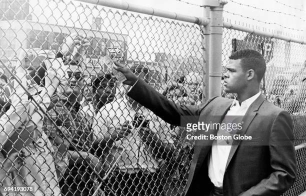 Boston Red Sox player Reggie Smith passes out a game ticket at the play gate before Game 2 of the World Series against the St. Louis Cardinals at...
