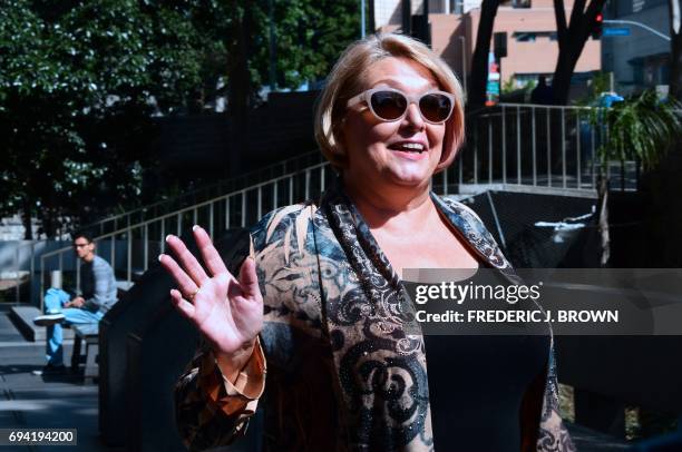 Samantha Geimer waves to the press before entering the courthouse in Los Angeles, California on June 9, 2017. Geimer is expected to ask the court to...