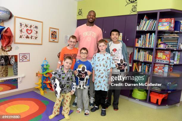 Martellus Bennett takes a picture with Dylan, Ransom, Ryan, Travis, and Tri at Boston Children's Hospital June 9, 2017 in Boston, Massachusetts.