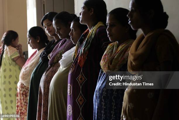 Surrogates stand at Dr Nayanaben Patel's infertility centre in the district of Anand in Gujarat. Most of the surrogates are second timers, and say...