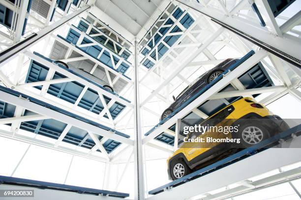 Vehicles sit inside the Carvana Co. Car vending machine in Frisco, Texas, U.S., on Thursday, June 8, 2017. The U.S. Automotive industry may be...