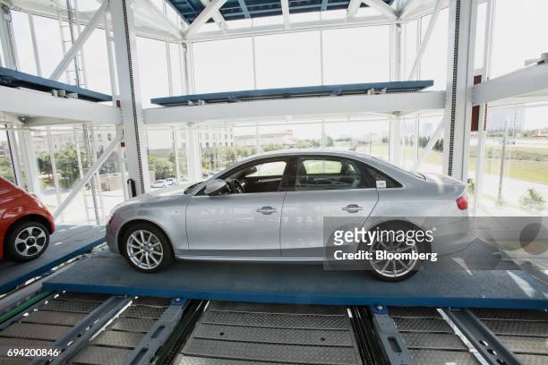Vehicle is moved onto the retrieval platform at the Carvana Co. Car vending machine in Frisco, Texas, U.S., on Thursday, June 8, 2017. The U.S....