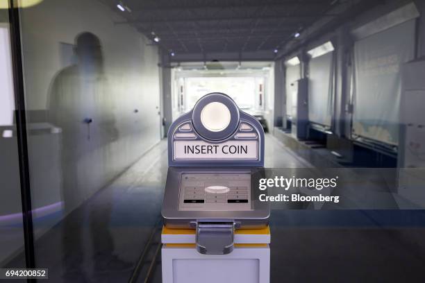 Coin machine stands at the Carvana Co. Car vending machine in Frisco, Texas, U.S., on Thursday, June 8, 2017. The U.S. Automotive industry may be...