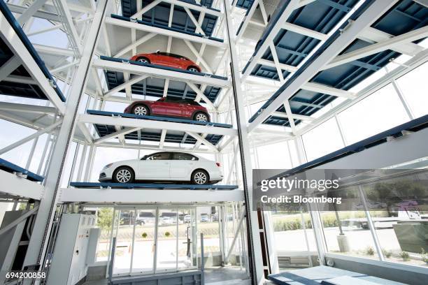 Vehicles sit inside the Carvana Co. Car vending machine in Frisco, Texas, U.S., on Thursday, June 8, 2017. The U.S. Automotive industry may be...