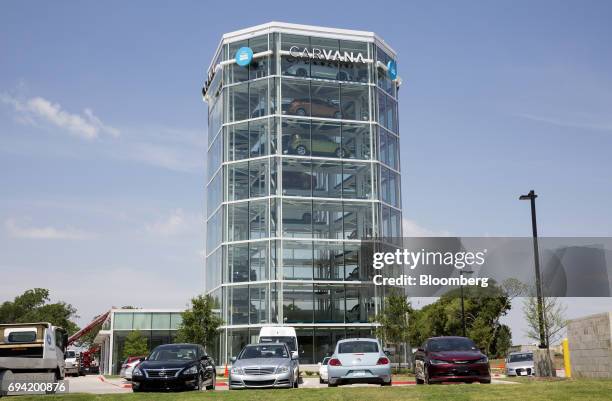 Vehicles sit parked outside the Carvana Co. Car vending machine in Frisco, Texas, U.S., on Thursday, June 8, 2017. The U.S. Automotive industry may...