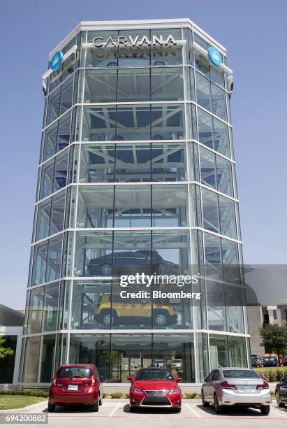 Vehicles sit parked outside the Carvana Co. Car vending machine in Frisco, Texas, U.S., on Thursday, June 8, 2017. The U.S. Automotive industry may...