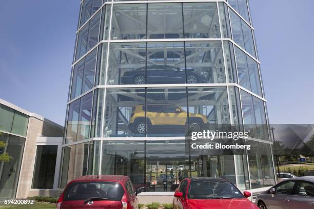 Vehicles sit inside the Carvana Co. Car vending machine in Frisco, Texas, U.S., on Thursday, June 8, 2017. The U.S. Automotive industry may be...