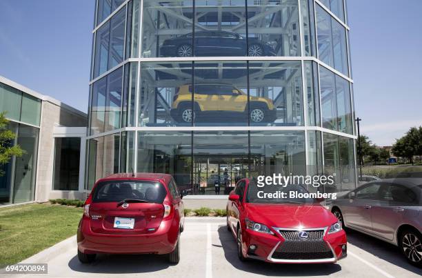 Vehicles sit parked outside the Carvana Co. Car vending machine in Frisco, Texas, U.S., on Thursday, June 8, 2017. The U.S. Automotive industry may...