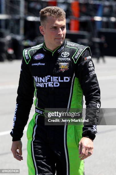 Dakoda Armstrong, driver of the WinField United Toyota, stands in the garage area during practice for the NASCAR XFINITY Series Pocono Green 250 at...