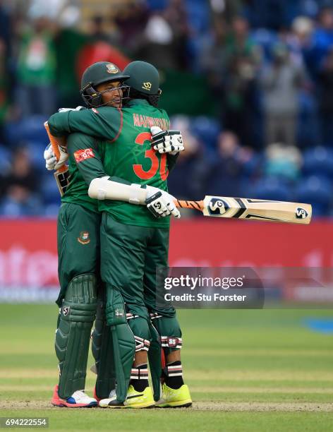 Bangladesh batsmen Shakib Al Hasan and Mohammad Mahmudullah celebrate after Hasan had reached his century during their partnership during the ICC...