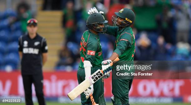 Bangladesh batsmen Shakib Al Hasan and Mohammad Mahmudullah celebrate after Hasan had reached his century during their partnership during the ICC...