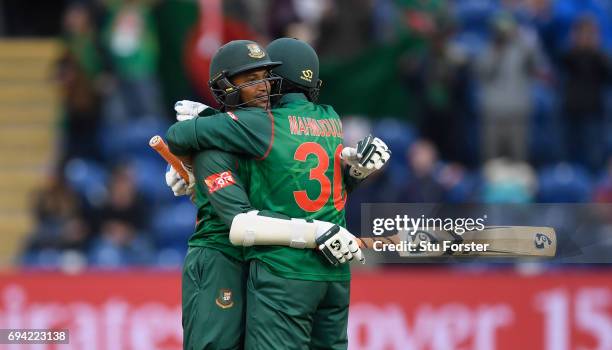 Bangladesh batsmen Shakib Al Hasan and Mohammad Mahmudullah celebrate after Hasan had reached his century during their partnership during the ICC...