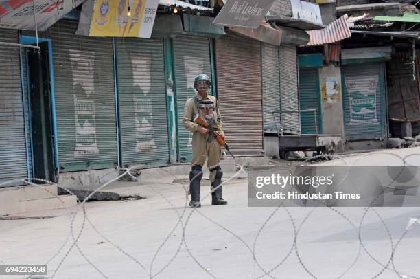 Paramilitary soldier stands guard during a curfew and strike on June 9, 2017 in downtown Srinagar, India. The valley's separatist leaders had called...