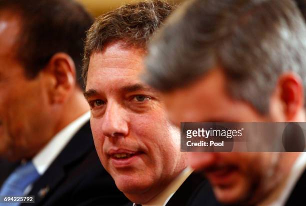 Argentine Treasury Minister Nicolas Dujovne looks on next to Cabinet Chief Marcos Pena during a press conference as part of an official visit of...