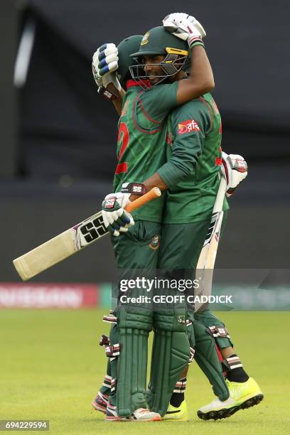 Bangladesh's Mahmudullah and Bangladesh's Mosaddek Hossain celebrate their victory in the ICC Champions Trophy match between New Zealand and...