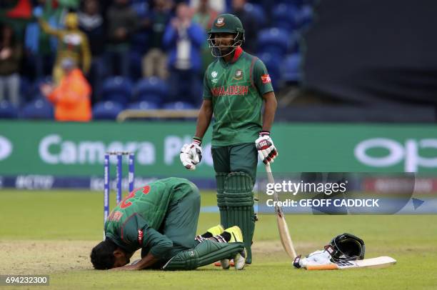 Bangladesh's Mahmudullah celebrates reaching 100 during the ICC Champions Trophy match between New Zealand and Bangladesh in Cardiff on June 9, 2017....