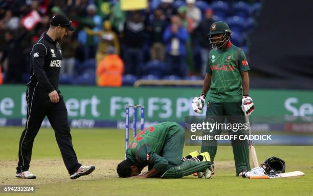 Bangladesh's Mahmudullah celebrates reaching 100 during the ICC Champions Trophy match between New Zealand and Bangladesh in Cardiff on June 9, 2017....