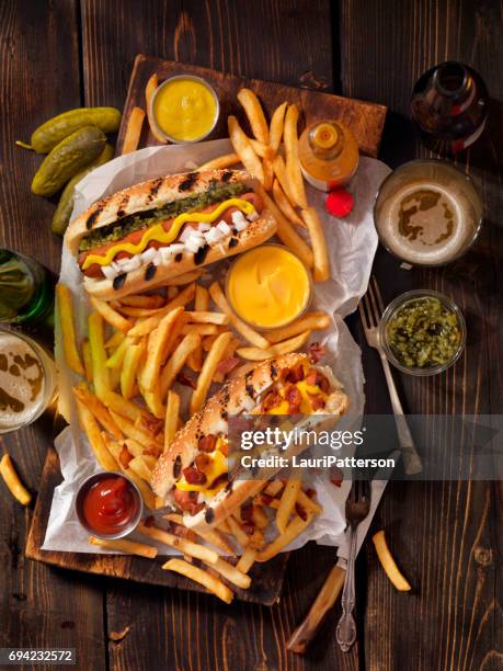gourmet bbq hotdogs, fries and beers - cornucopia table stock pictures, royalty-free photos & images