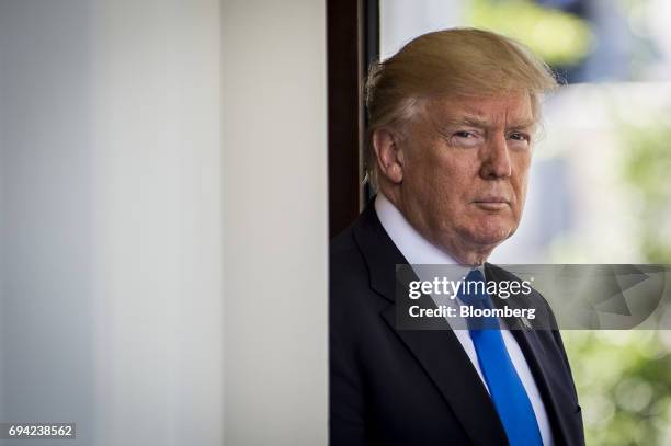 President Donald Trump stands outside the West Wing of the White House as Klaus Iohannis, Romania's president, not pictured, arrives at the West Wing...