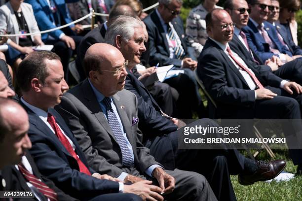 White House Chief of Staff Reince Priebus , US Secretary of Commerce Wilbur Ross , US Secretary of State Rex W. Tillerson and others listen as US...