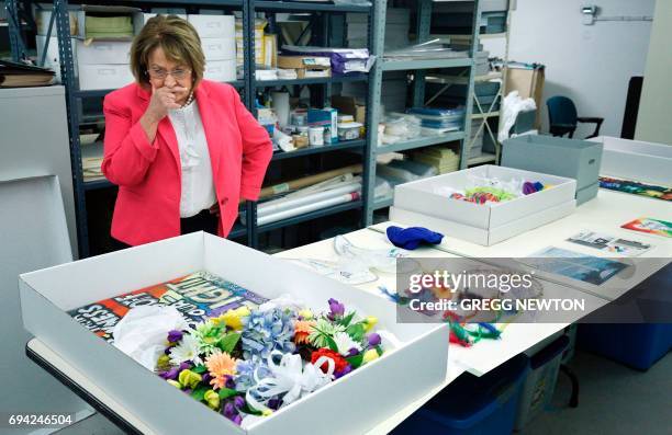 Teresa Jacobs, Mayor of Orange County, Florida, looks over artifacts left as memorials in the wake of the Pulse nightclub shootings, at the History...