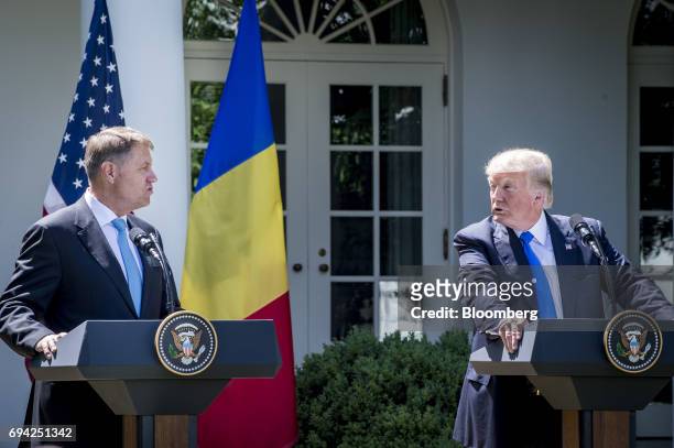 President Donald Trump speaks while Klaus Iohannis, Romania's president, left, listens during a joint press conference in the Rose Garden of the...