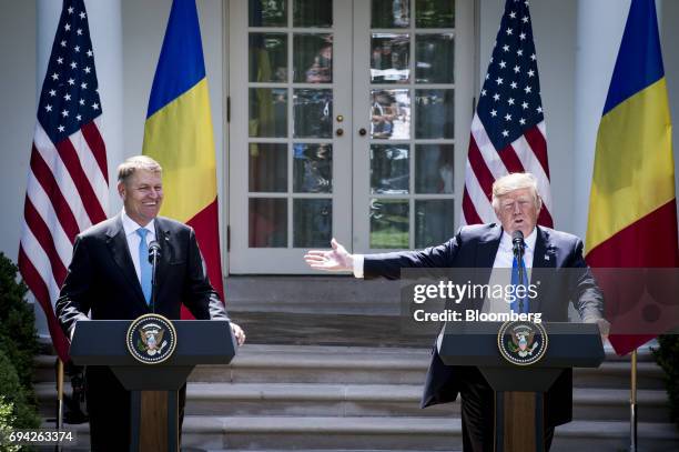 President Donald Trump speak as Klaus Iohannis, Romania's president, left, smiles during a joint press conference in the Rose Garden of the White...