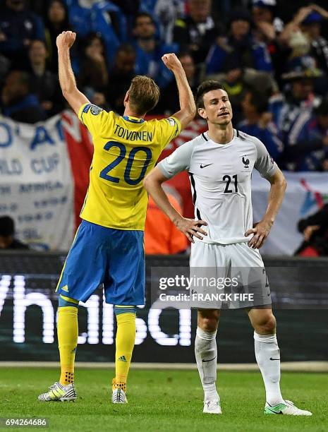 Sweden's forward Ola Toivonen celebrates scoring next to France's defender Laurent Koscielny at teh end of the FIFA World Cup 2018 qualification...