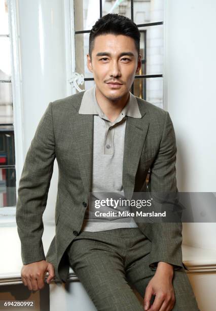 Hu Bing attends London Fashion Week Men's June 2017 collections on June 9, 2017 in London, England.