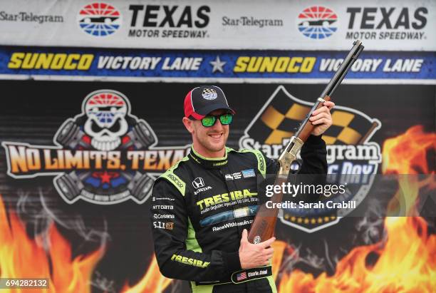 Charlie Kimball, driver of the Tresiba Chip Ganassi Racing Teams Honda, poses for a photo after winning the pole award after qualifying for the...