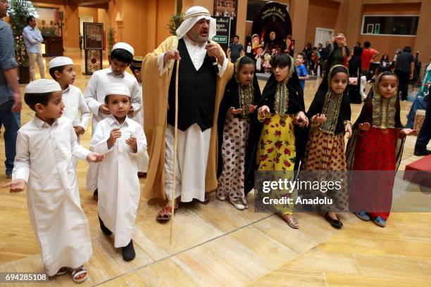 Children have fun during a traditional event named "Garangaou", organized within Muslims' holy month of Ramadan in Doha, Qatar on June 09, 2017. The...