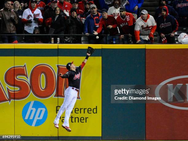 Rightfielder Lonnie Chisenhall of the Cleveland Indians attempts to field a fly ball against the wall during Game 1 of the World Series against the...