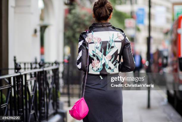 Thai Janie Tienphosuwan actress and model wearing a leather jacket, pink Givenchy bag during the London Fashion Week Men's June 2017 collections on...