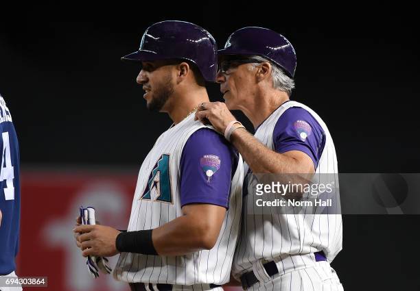 David Peralta of the Arizona Diamondbacks talks with first base coach Dave McKay after safely reaching base against the San Diego Padres at Chase...