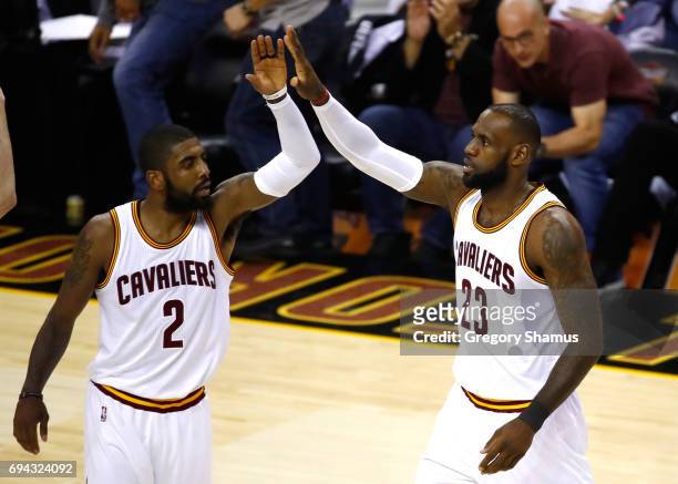 Kyrie Irving and LeBron James of the Cleveland Cavaliers celebrate after a play in the first quarter against the Golden State Warriors in Game 4 of...