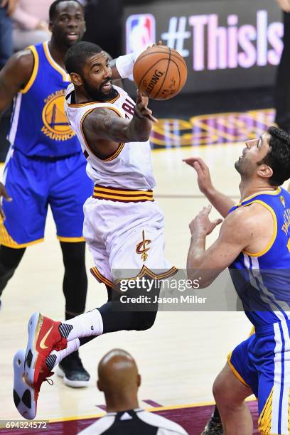 Kyrie Irving of the Cleveland Cavaliers looks to pass in the first quater against Zaza Pachulia of the Golden State Warriors in Game 4 of the 2017...