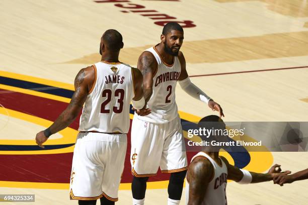 Kyrie Irving of the Cleveland Cavaliers high fives LeBron James of the Cleveland Cavaliers during the game against the Golden State Warriors in Game...