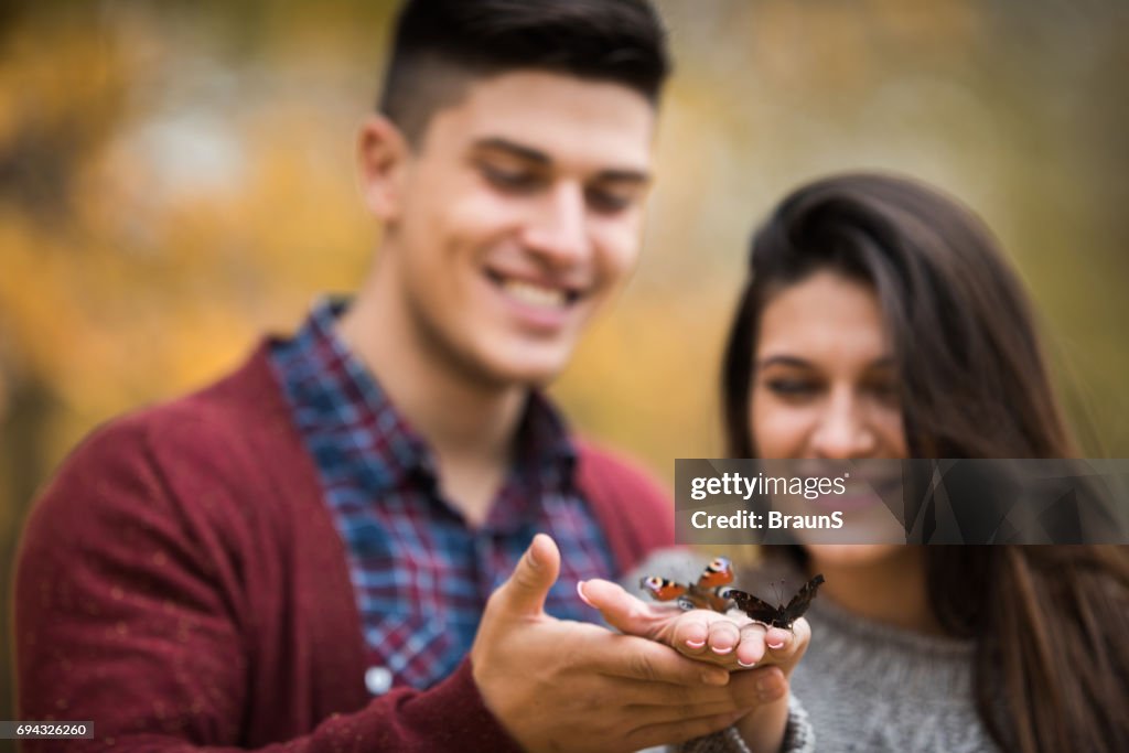 Butterflies in hands of happy couple.