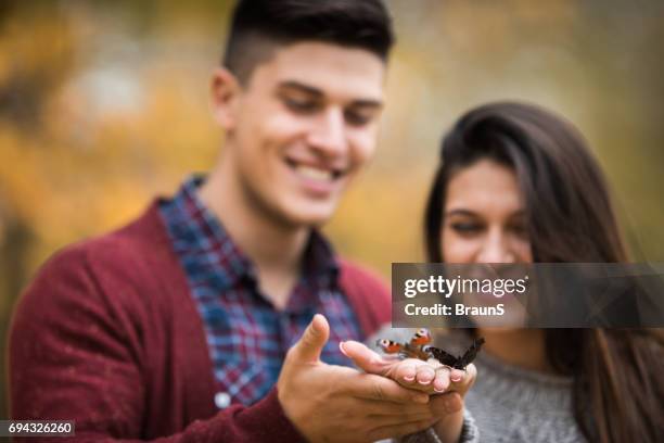 butterflies in hands of happy couple. - releasing butterfly stock pictures, royalty-free photos & images