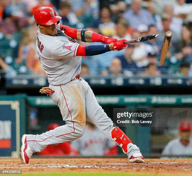 Yunel Escobar of the Los Angeles Angels of Anaheim breaks his bat as hr doubles in the third inning against the Houston Astros at Minute Maid Park on...
