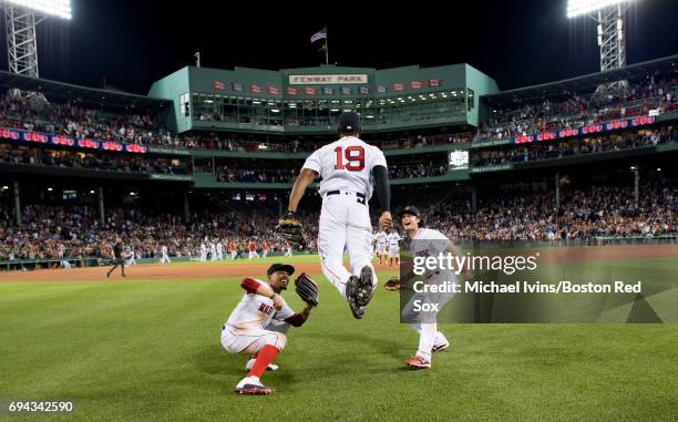 Mookie Betts and Andrew Benintendi react as Jackie Bradley Jr. #19 does the "ski jump" to celebrate his ninth inning home run and a 5-3 win over the...