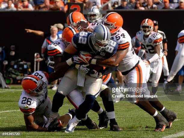Tight end Jason Witten of the Dallas Cowboys is tackled by linebackers Andra Davis, D'Qwell Jackson and safety Sean Jones of the Cleveland Browns...
