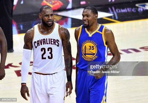 LeBron James of the Cleveland Cavaliers and Kevin Durant of the Golden State Warriors speak after a foul in the third quarter in Game 4 of the 2017...